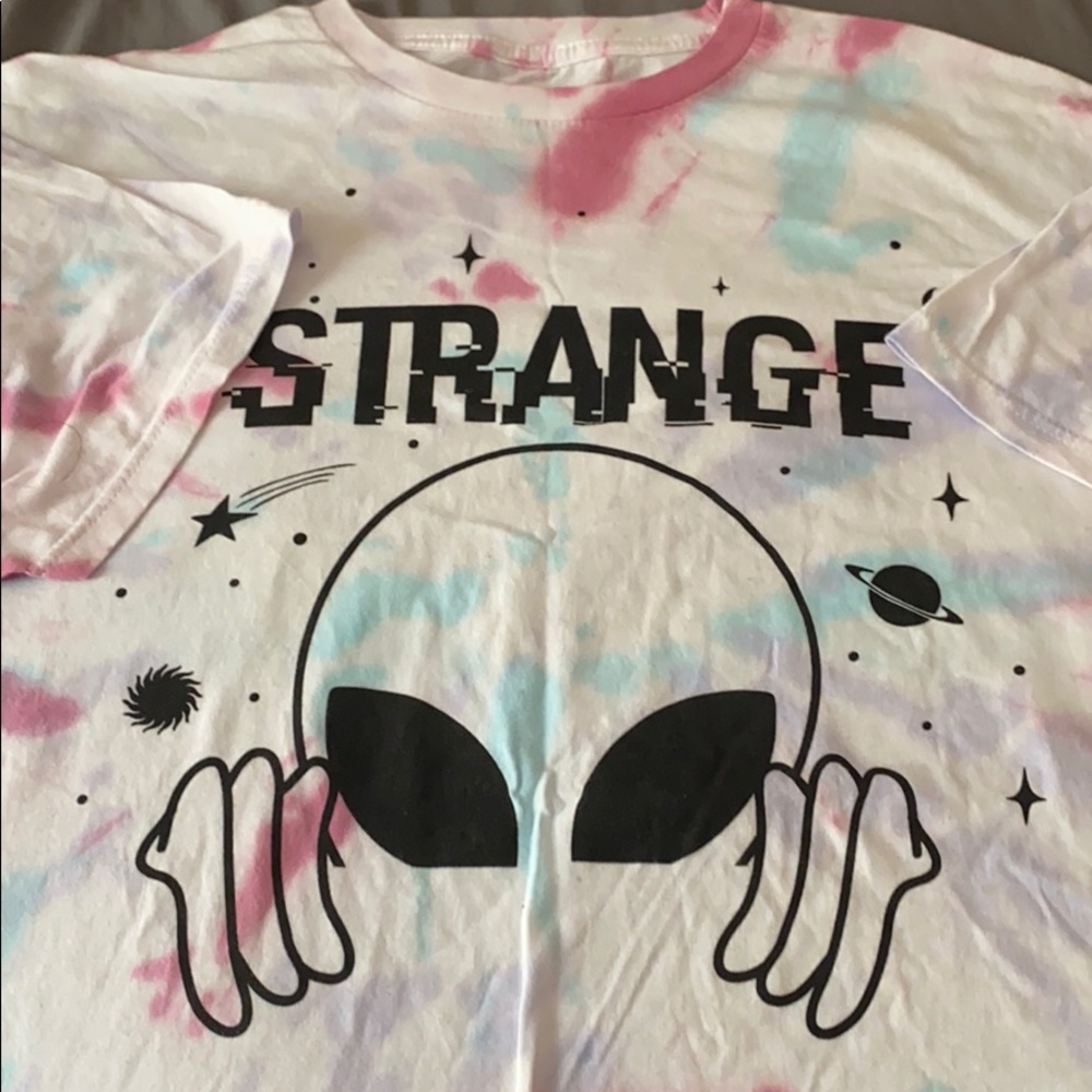 white tie dye shirt with a alien on it